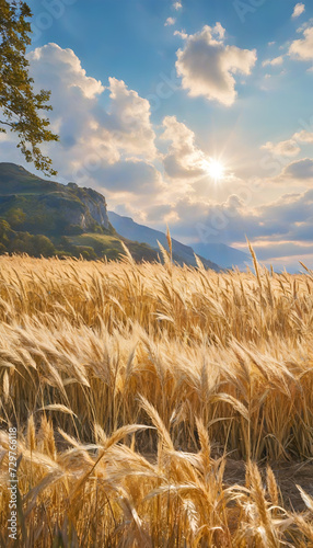 Wheat fallow field against the mountain view and the sun cloudburst. The wind sways the ears. Social media poster