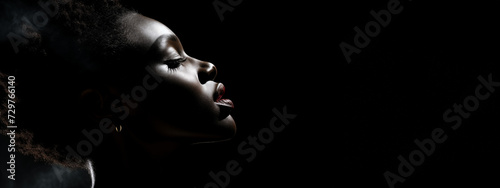 Close up of a model black woman face profile on a black background