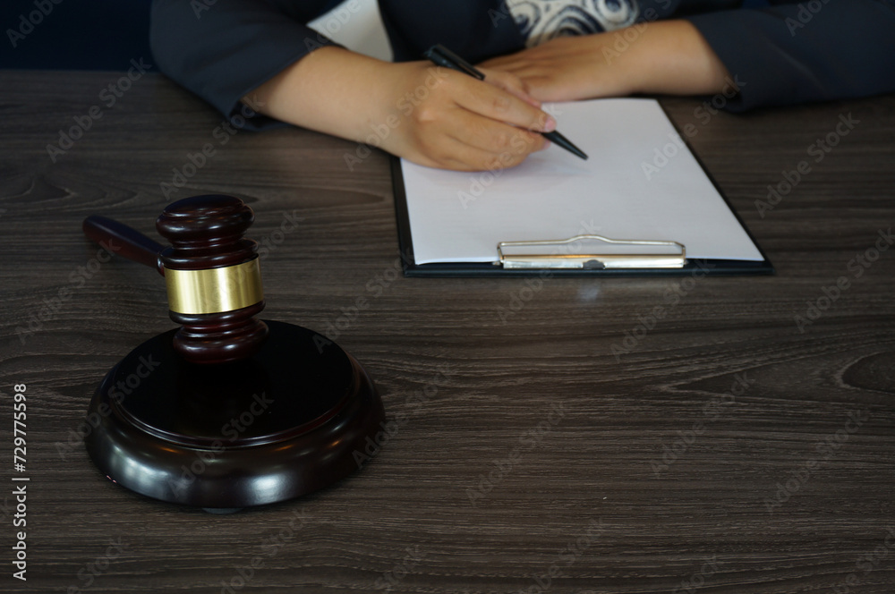 Legal counsel presents to the client a signed contract with gavel and legal law. Justice and lawyer law of advisor Concepts Legal counsel presents to the client a signed contract with gavel and legal law. Justice and lawyer law of advisor Concepts