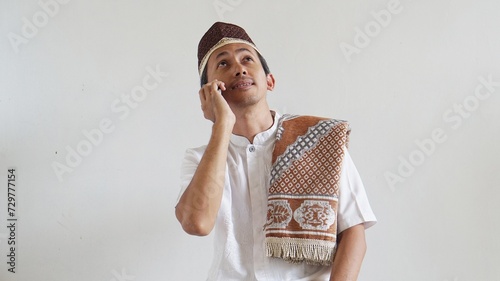 Asian Moslem man when in call using mobile phone photo