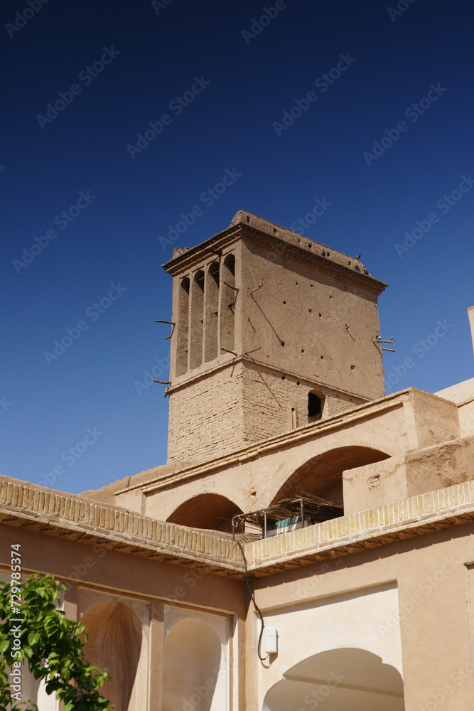 Yazd cityscape with old brick buildings and badgirs wind catching towers in Yazd, Iran