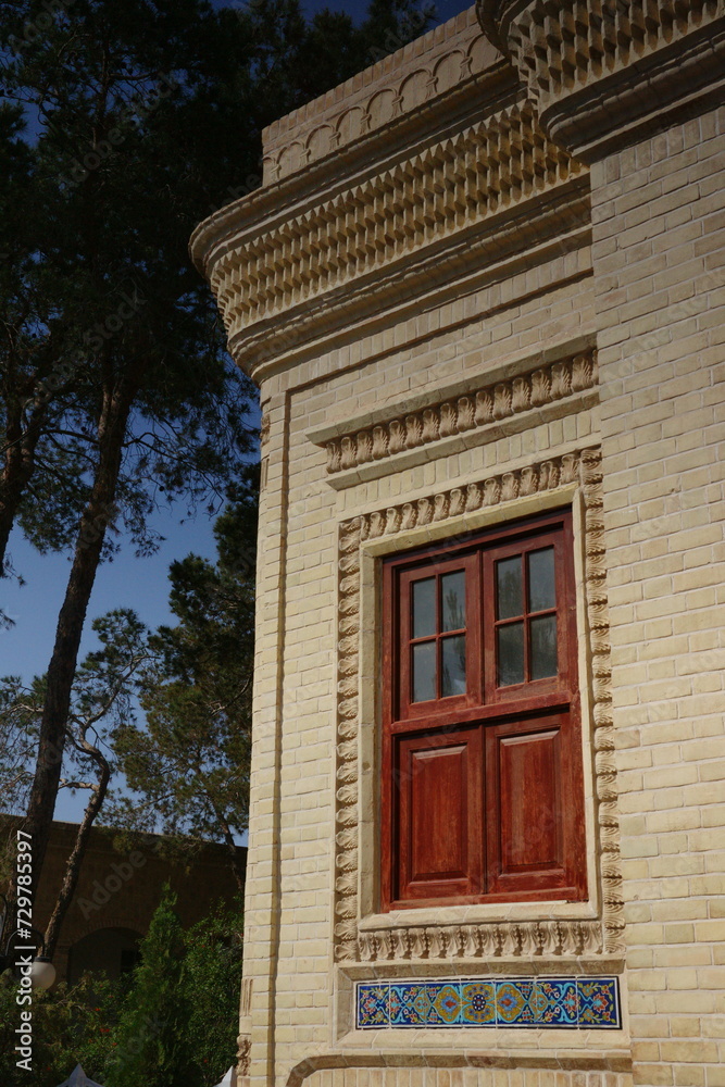 Facade of Yazd Atash Behram, the Zoroastrian highest grade of fire temple. There is a winged deity of the Ahura Mazda embedded on the building. Facade of Yazd Atash Behram, the Zoroastrian highest grade of fire temple. There is a winged deity of the Ahura Mazda embedded on the building.