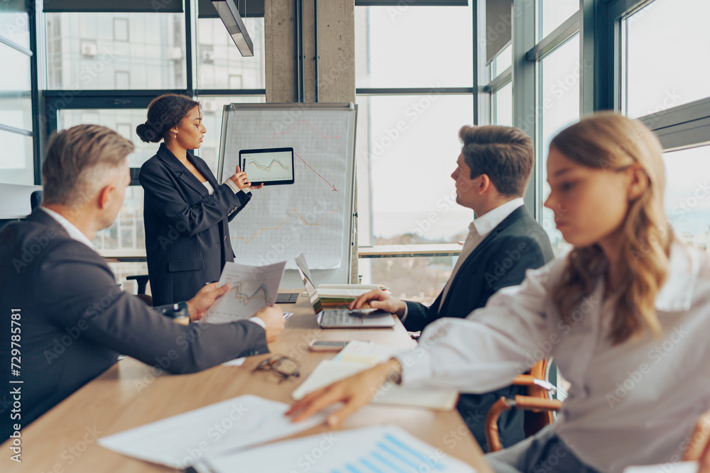 Obraz premium Team of business investors is discussing a new project in modern office. Concept of financing