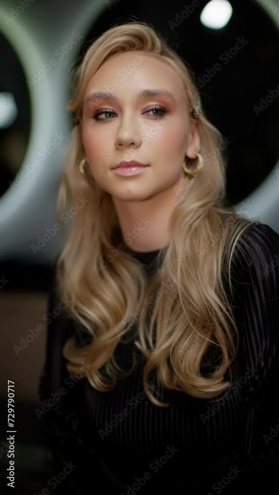 A sophisticated young woman in a black dress with a refined makeup look. A sophisticated young woman in a black dress with a refined makeup look.