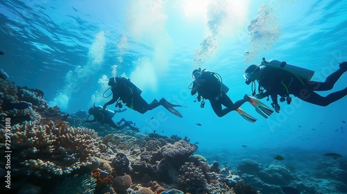 Group of scuba divers exploring coral reef