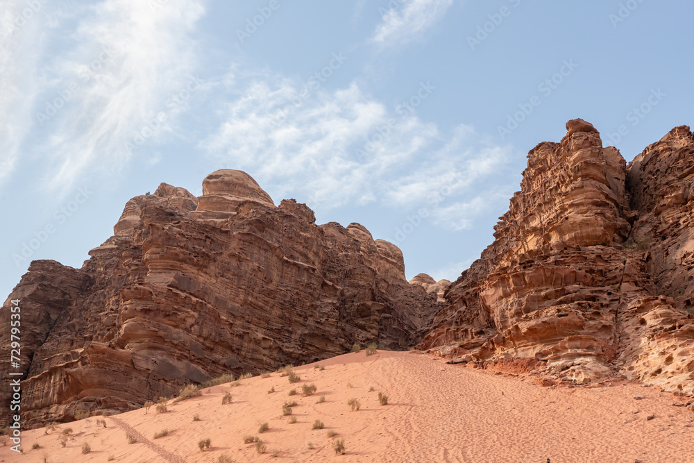 Unforgettable high mountains in the endless sandy red desert of the Wadi Rum near Amman in Jordan
