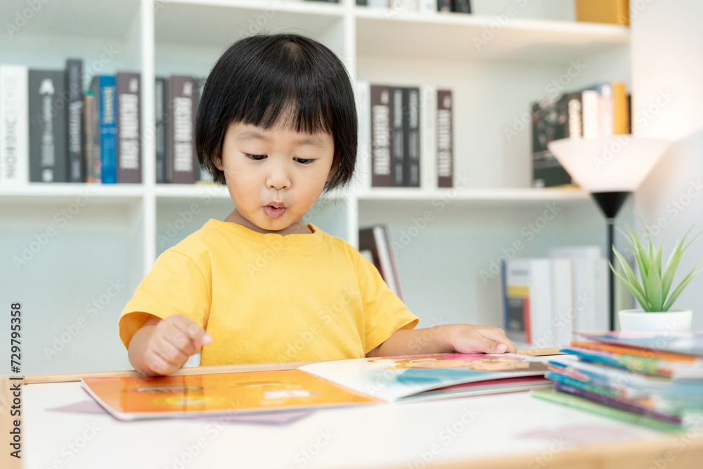 Happy Asian children relax read book at home. daughter and reading a story. learn development, childcare, laughing, education, storytelling, practice, imagine, reduce addiction mobile phone Happy Asian children relax read book at home. daughter and reading a story. learn development, childcare, laughing, education, storytelling, practice, imagine, reduce addiction mobile phone