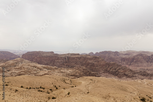 View from distance from high hill to famous gorge in which it is located thr Nabatean Kingdom of Petra in the Wadi Musa city in Jordan