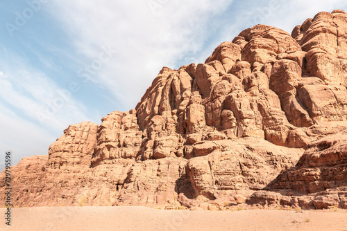 The beautifully shaped peaks of high mountain ranges in the red desert of the Wadi Rum near Amman in Jordan