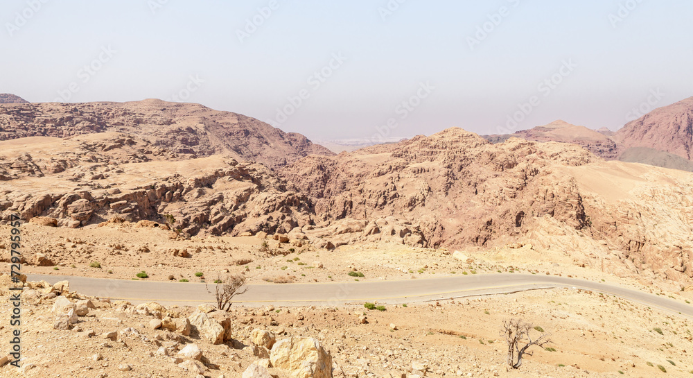 View of low mountains in gorge Wadi Al Ghuwayr or An Nakhil and the wadi Al Dathneh from the road leading to it near Amman in Jordan