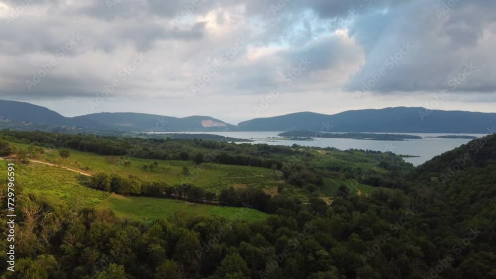 Flight over beautiful forest and lake surrounded by mountains. Fly towards the big pond reservoir and green meadows among woodland top view video. Environment ecology protection Flight over beautiful forest and lake surrounded by mountains. Fly towards the big pond reservoir and green meadows among woodland top view video. Environment ecology protection