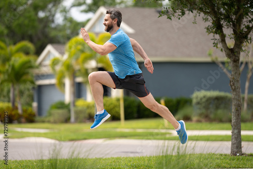 Fit man fitness model workout outdoor. Man runner on the street running for exercise. Man running in at spring morning. Running man. Male runner jogging. Guy training outdoors. Sport, cardio concept.