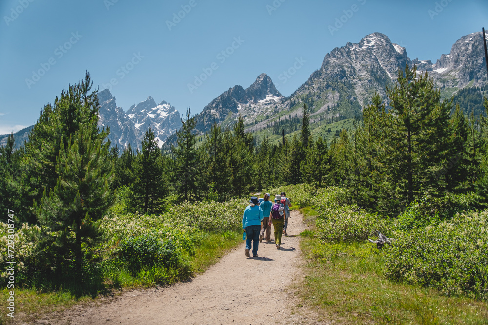 People hiking toward the Teton mountain range in Grand Teton National Park
