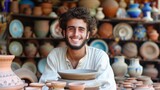 A young man from the Middle East, with a proud expression and a piece of pottery, is showcasing his work in a market in Marrakech, Morocco