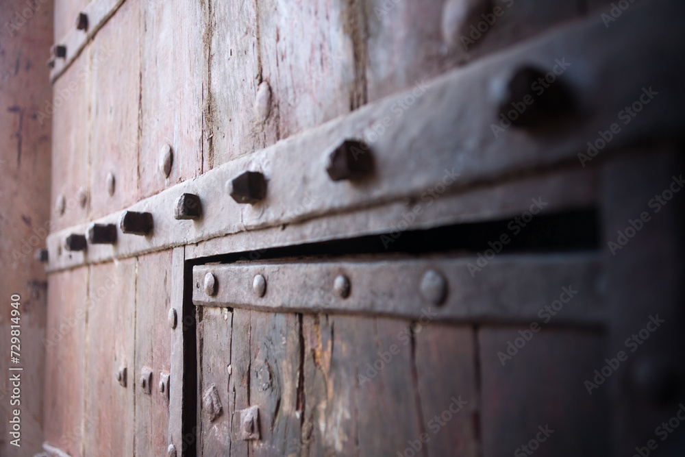 Ancient wooden gate,close up ,in Amber Fort,Jaipur ,India Ancient wooden gate,close up ,in Amber Fort,Jaipur ,India