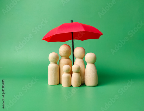 A wooden peg doll family cover by red umbrella