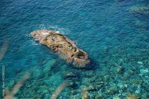 Rocky sea floor visible through crystal clear turqoise water of Mediterranean sea in Cinque Terre，Italy