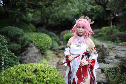 Portrait of a beautiful young woman game cosplay on japanese garden