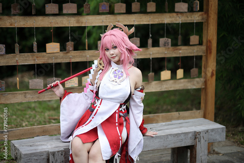 Portrait of a beautiful young woman game cosplay on japanese garden