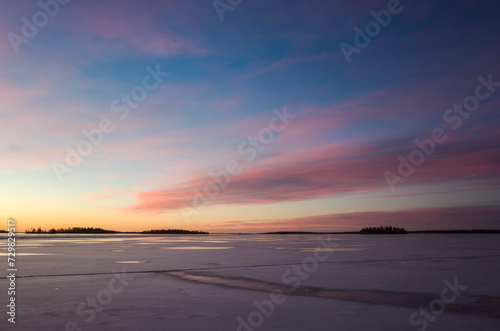 Glowing pink and yellow morning sky over frozen lake M  laren at sunrise  V  ster  s  winter in Sweden