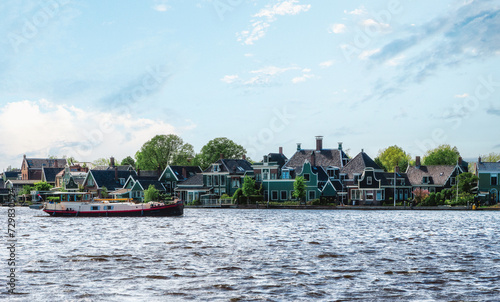 Traditional Zaan houses with the painted wooden facades on the banks of the river Zaan.