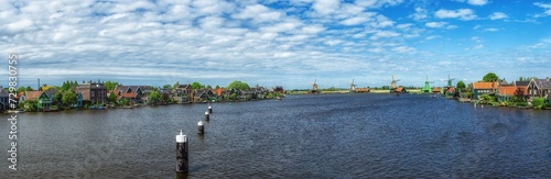 Traditional Zaan houses with the painted wooden facades on the banks of the river Zaan. photo