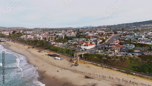 Wallpaper Mural Aerial View of California beach town with surfers crossing bridge over train tracks Torontodigital.ca