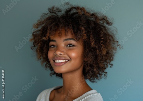 African American model girl with colorful sweatshirt in professional colorful photo studio background