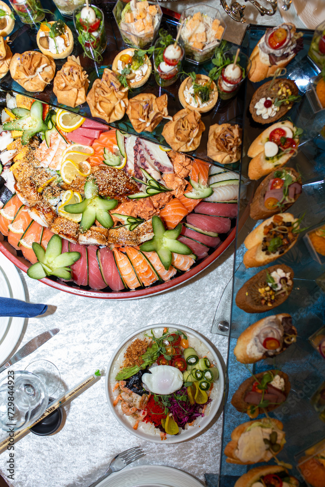 Fototapeta premium Catering Buffet with Sushi, Canapes, and Other Delicacies for Party or Event
