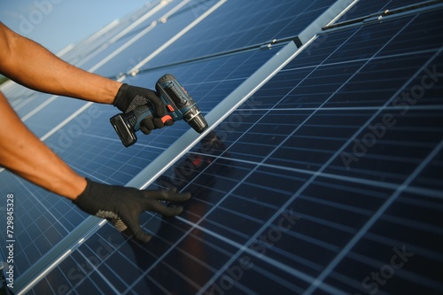 close-up of worker's hands installing solar panels