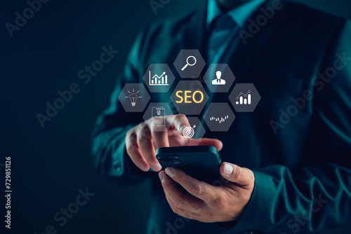 Businessman using smartphone for analysis SEO Search Engine Optimization Marketing Ranking Traffic Website Internet Business Technology Concept, digital online marketing, Business global internet.