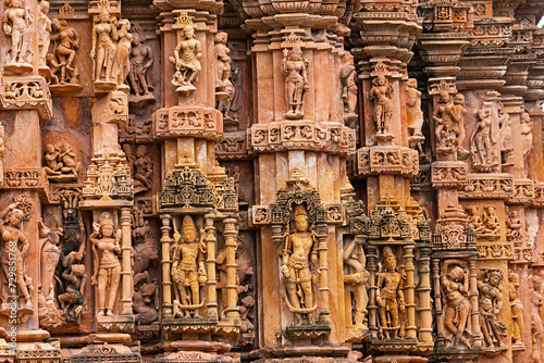 Carving Sculptures of Hindu deities on the Sun Temple of Jhalarapatan, Rajasthan, India.