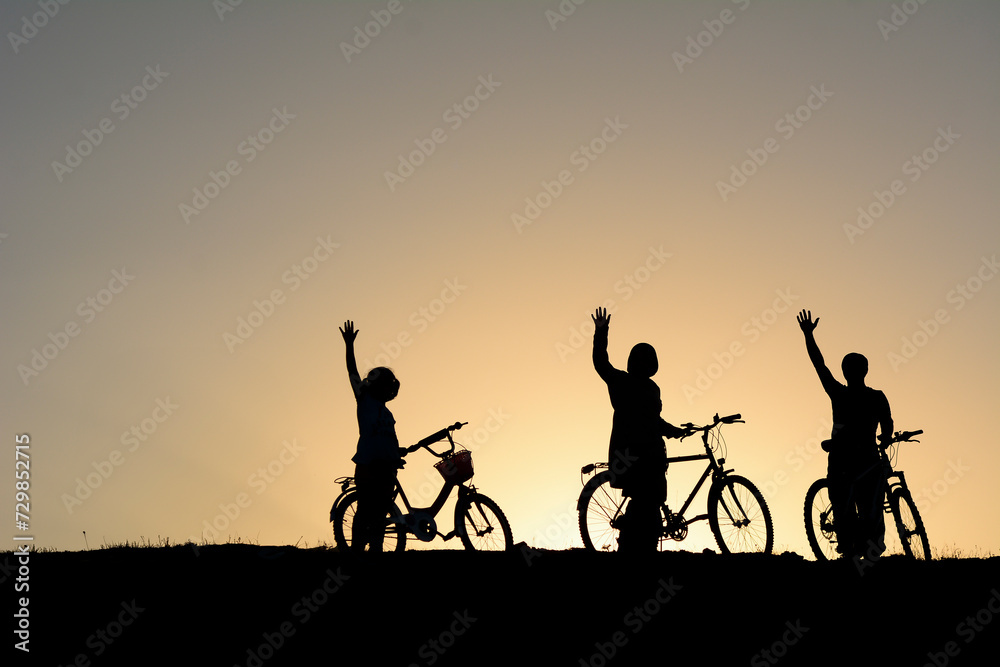 Fototapeta premium Being in nature with a family bike trip consisting of mother, father and child