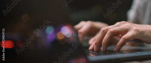 Businesswoman hand working on a laptop, bokeh blurred for text copy space, image size horizontal