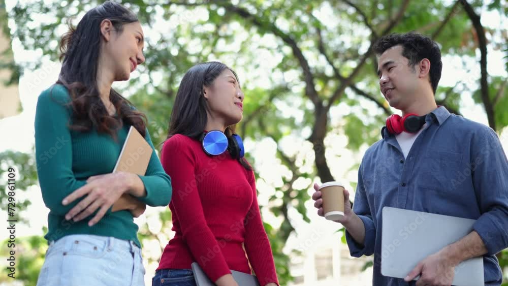 Group of confident Asian students wearing headphones, relaxing, studying information, talking, sharing ideas, communicating, seeking knowledge, online, and managing on laptops at university. Group of confident Asian students wearing headphones, relaxing, studying information, talking, sharing ideas, communicating, seeking knowledge, online, and managing on laptops at university.