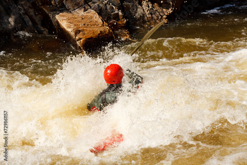 A Person In A Red Helmet Is Swimming In A River © Aleksey