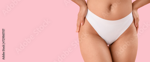 Beautiful young woman with stretch marks on her body against pink background with space for text, closeup