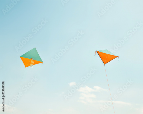 Two vibrant kites soaring in the clear blue sky  symbolizing fun and freedom.
