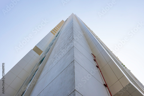 A low angle view of a modern office building towering like a pyramid.