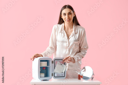 Young woman in pajamas usin...