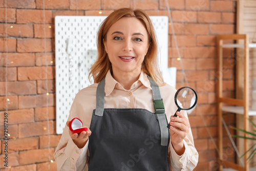 Female jeweler with engagem...