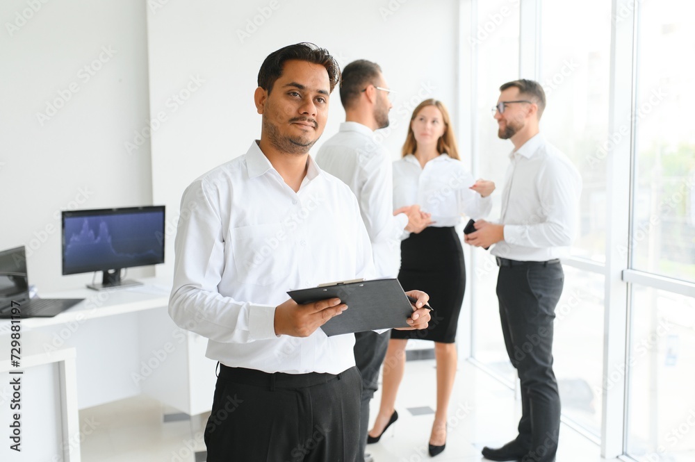 Business people stand on the background of the office corridor Business people stand on the background of the office corridor