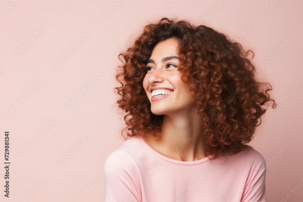 Portrait of a happy young woman with curly hair on pink background Portrait of a happy young woman with curly hair on pink background