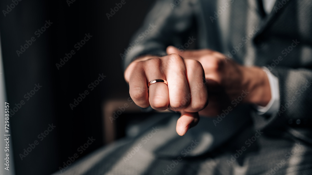 Classic wedding ring on the groom's hand. Wedding ring on the groom's finger. 