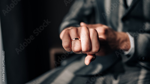 Classic wedding ring on the groom's hand. Wedding ring on the groom's finger.  © Reda