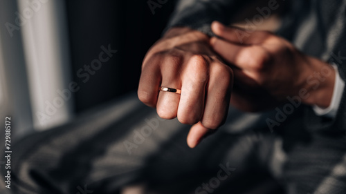 Classic wedding ring on the groom's hand. Wedding ring on the groom's finger. 