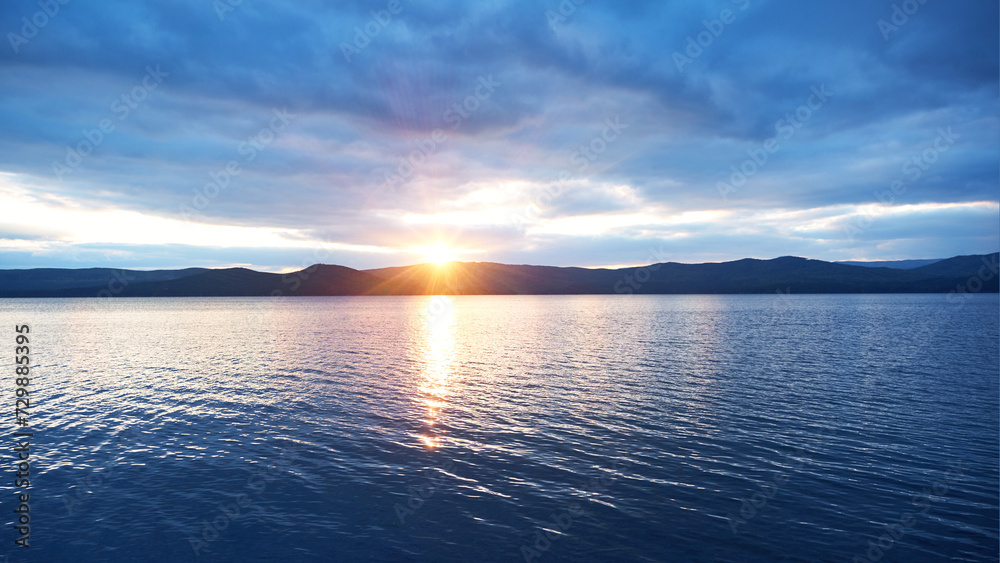 Lake sunset over the mountains