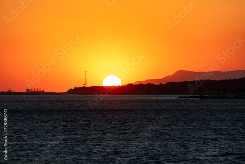 Hiding behind an island at sea. Sunset