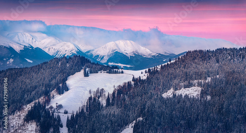 Untouched winter landscape. Chornogora mountain range in the morning mist. Colorful winter sunrise in the mountain forest, Il'tsi village location, Ukraine. Beauty of nature concept background.