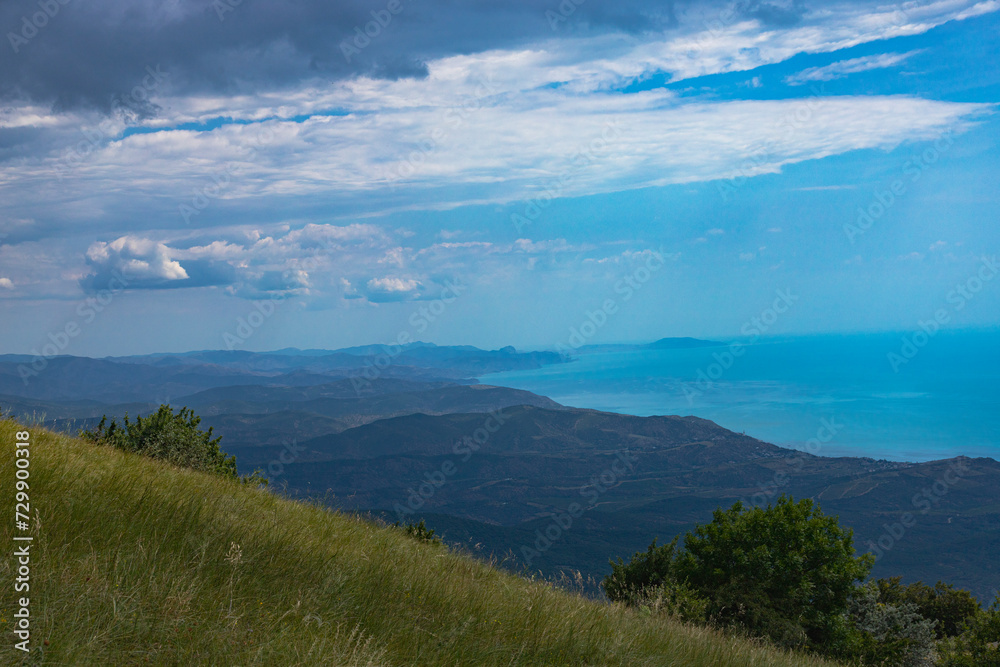 View from the top of Mount Demerdzhi to the mountainous green valley and the sea. Landscape